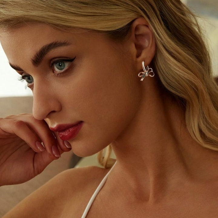 silver bow dangling earrings