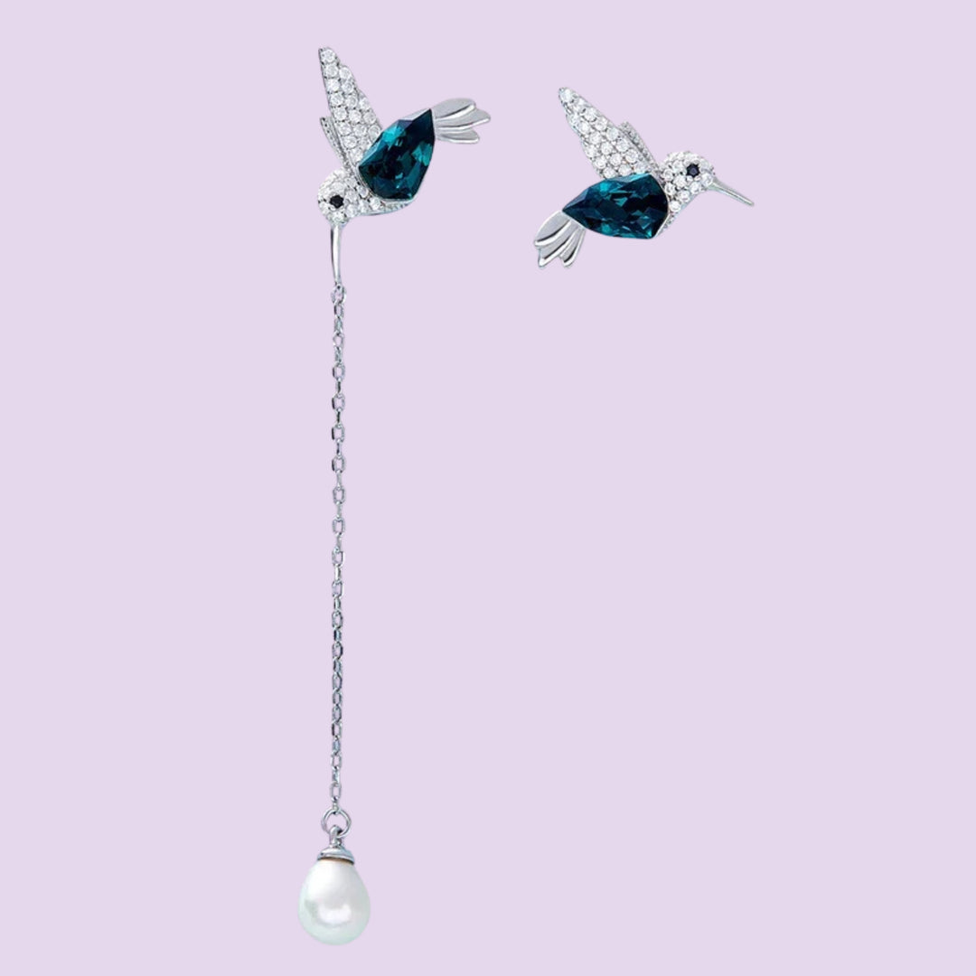 Hummingbird asymmetrical earrings featuring blue hummingbird designs with a long pearl drop